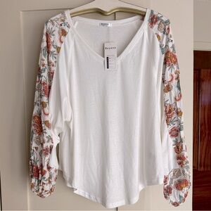 Beyove brand Size XL white with floral sleeves.